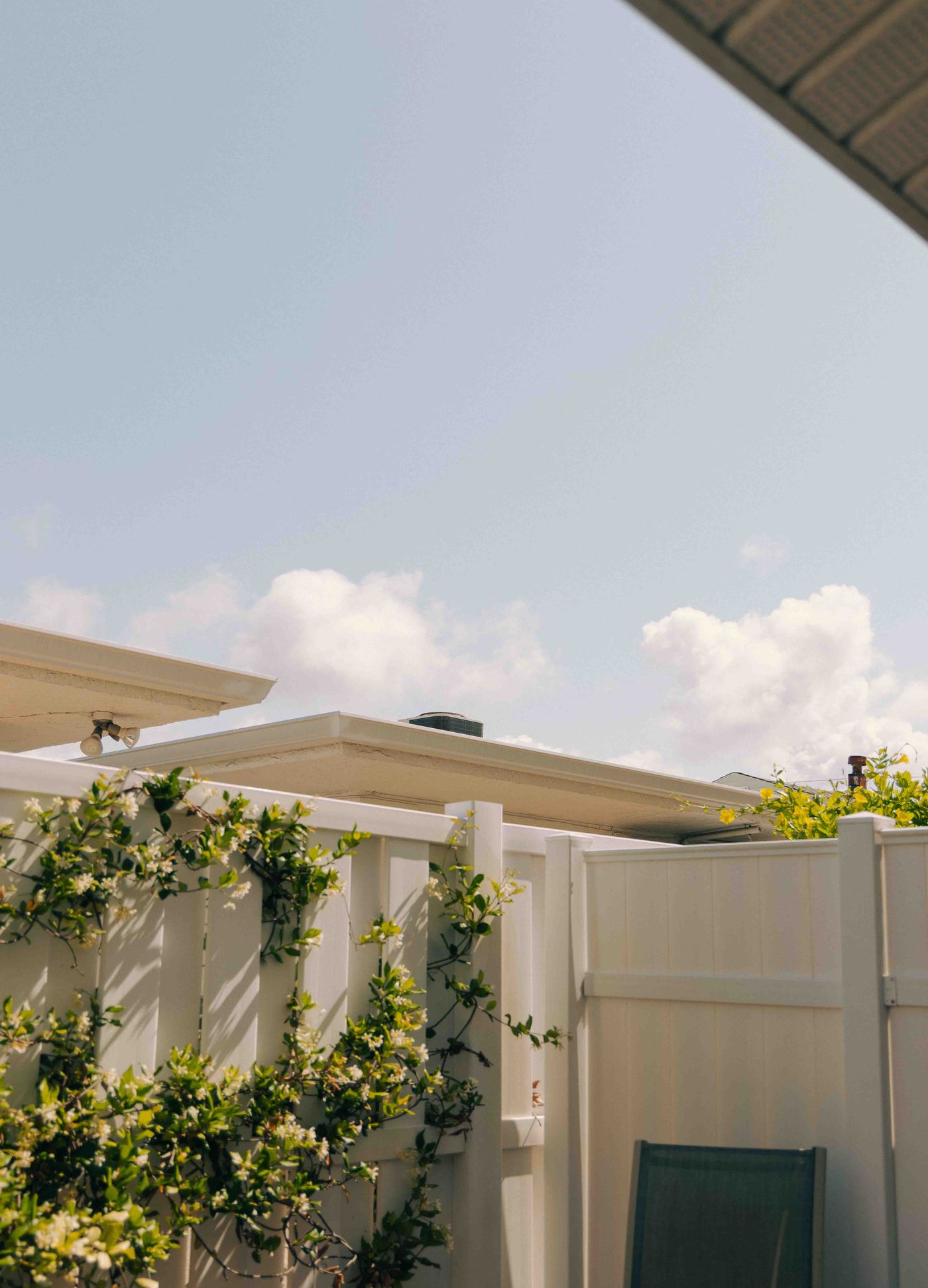 White vinyl privacy and picket fence in a residential backyard